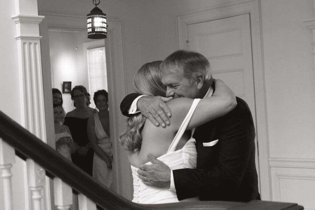 Bride and father of the bride embracing after the first look.