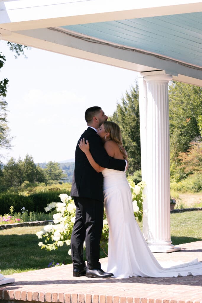 Bride and groom hugging after first look.