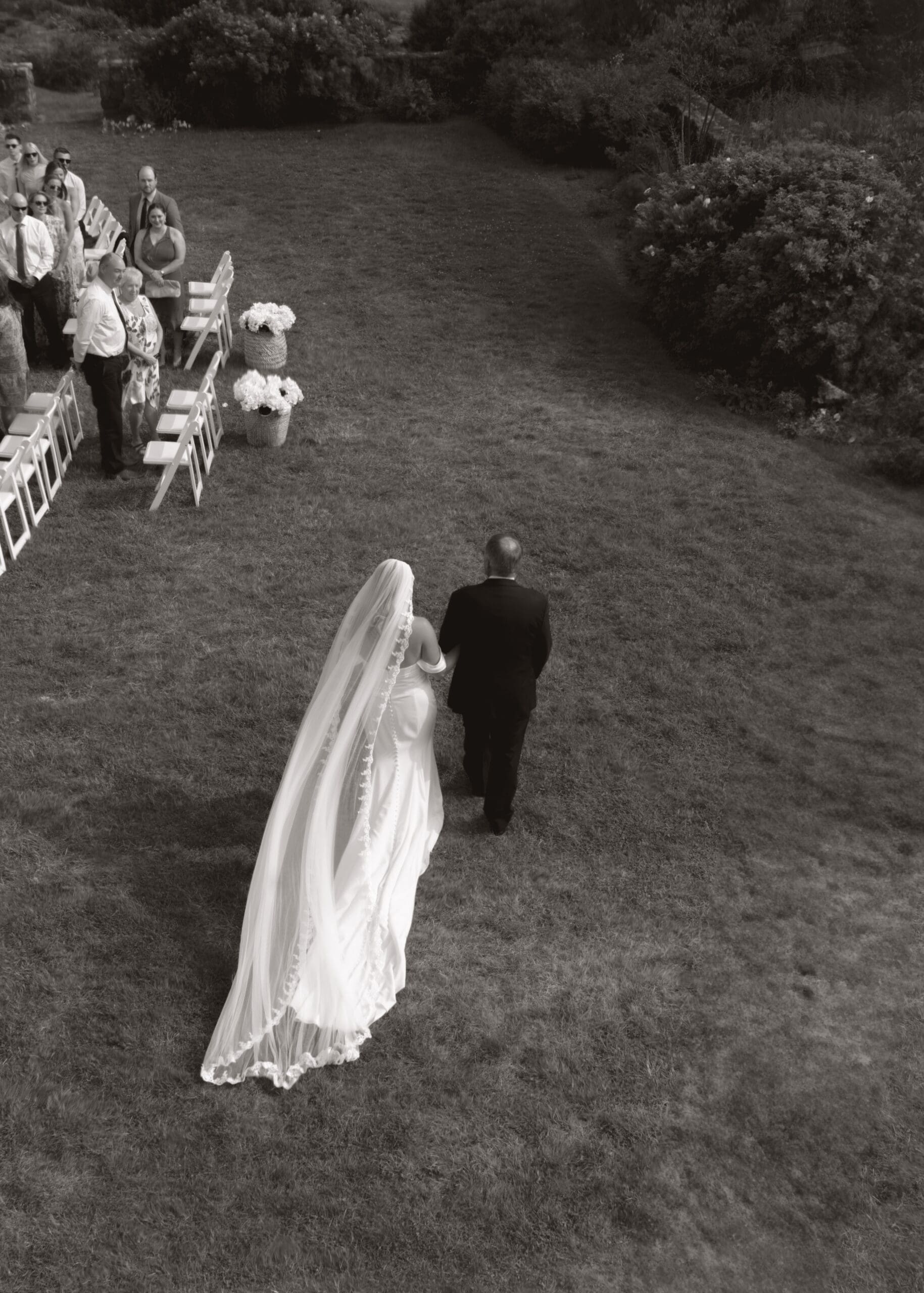 Bride and father of the bride walking down the isle.