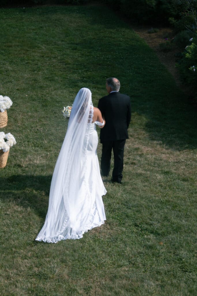 Bride and father of the bride walking down the isle.