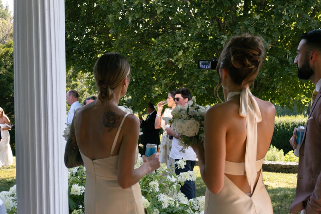 Bridesmaids taking content during cocktail hour.