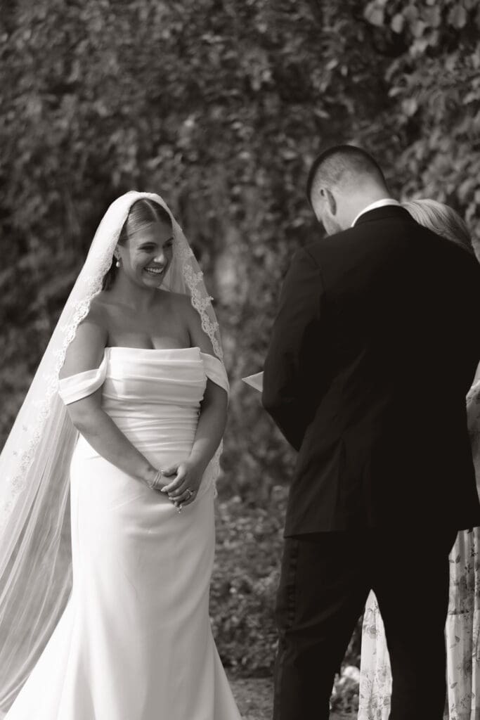 Bride and groom in black and white at the alter.